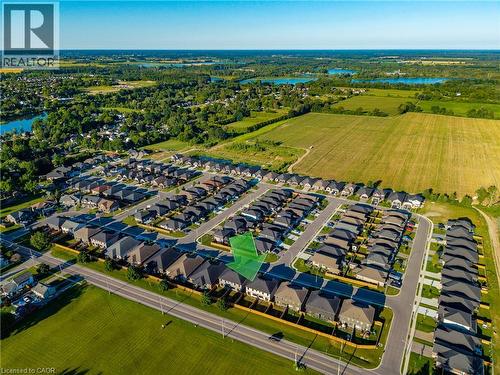 Aerial perspective of a developed residential neighborhood featuring rows of single-family homes with dark-toned roofing - 107 Amber Street, Waterford, ON - Outdoor With View