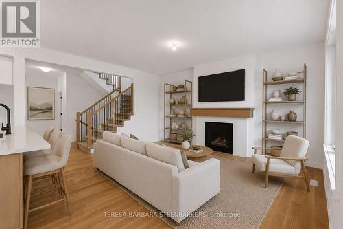 Virtually staged Family Room - 1164 Bronze Avenue, Clarence-Rockland, ON - Indoor Photo Showing Living Room With Fireplace