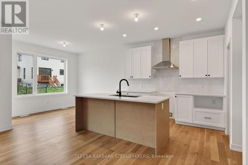 Center island with sink and bar style seating - 1164 Bronze Avenue, Clarence-Rockland, ON - Indoor Photo Showing Kitchen