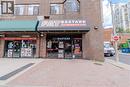 Brick facade commercial building with ground-level retail spaces and upper-level windows - 96 Gerrard St E, Toronto, ON 