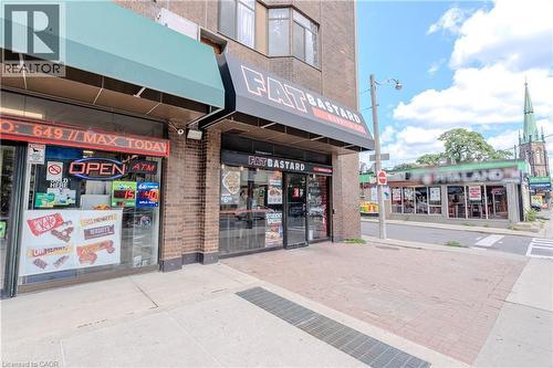 Street-level commercial space featuring brick facade and prominent storefront windows - 96 Gerrard St E, Toronto, ON 