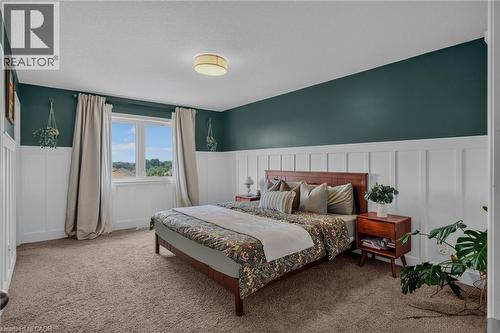 Bedroom featuring a window with natural light, board and batten wainscoting, and carpet flooring - 174 Woodway Trail, Simcoe, ON - Indoor Photo Showing Bedroom