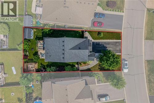 Aerial perspective showcasing a property with a dark shingle roof and a paved driveway - 174 Woodway Trail, Simcoe, ON - 