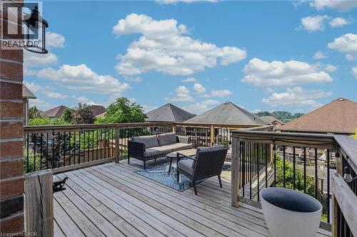 Wood-finish decking with wood railing and black balusters - 174 Woodway Trail, Simcoe, ON - Outdoor With Deck Patio Veranda
