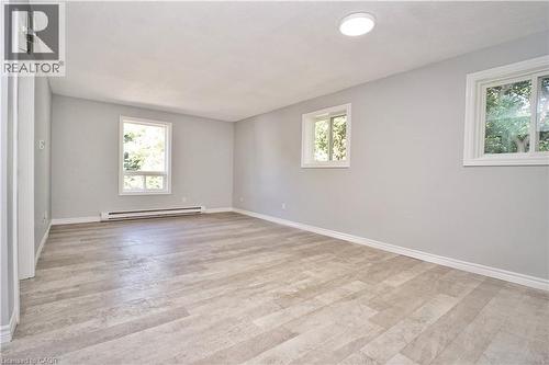 Light gray painted walls and wood-finish flooring define this room - 119 Cedar Street S Unit# 14, Kitchener, ON - Indoor Photo Showing Other Room