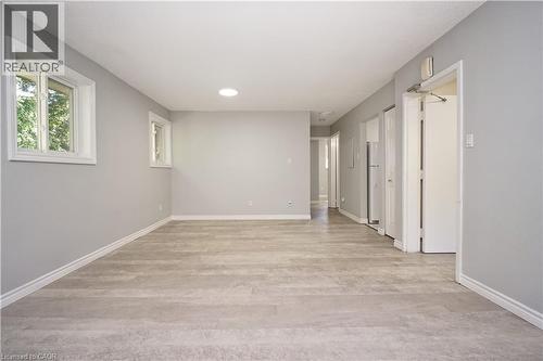 Spacious room featuring light wood-finish flooring, two windows with white trim, and a ceiling-mounted light fixture - 119 Cedar Street S Unit# 14, Kitchener, ON - Indoor Photo Showing Other Room
