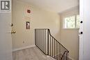 Stairwell with light-toned walls, wood-finish flooring, and black metal railing - 119 Cedar Street S Unit# 14, Kitchener, ON  - Indoor Photo Showing Other Room 