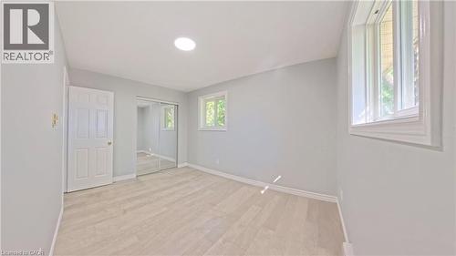 Spacious room featuring wood-finish flooring, light grey walls, and a recessed ceiling light - 119 Cedar Street S Unit# 14, Kitchener, ON - Indoor Photo Showing Other Room