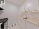Kitchen featuring white cabinetry, subway tile backsplash, speckled countertops, stainless steel sink with gooseneck faucet, and tile flooring - 119 Cedar Street S Unit# 14, Kitchener, ON  - Indoor Photo Showing Kitchen 