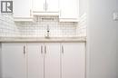White cabinetry with brushed nickel hardware, light-toned countertop, and classic subway tile backsplash - 119 Cedar Street S Unit# 14, Kitchener, ON  - Indoor Photo Showing Kitchen 