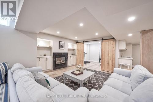 23 Trail Boulevard, Springwater, ON - Indoor Photo Showing Living Room With Fireplace