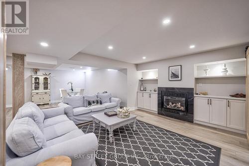 23 Trail Boulevard, Springwater, ON - Indoor Photo Showing Living Room With Fireplace