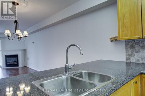 8 - 30 Mulligan Lane, Wasaga Beach, ON - Indoor Photo Showing Kitchen With Fireplace With Double Sink