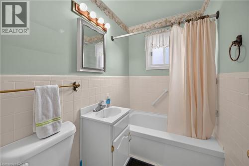 Bathroom featuring a white vanity with integrated sink, chrome faucet, and mirrored medicine cabinet - 155 Newlands Avenue, Hamilton, ON - Indoor Photo Showing Bathroom