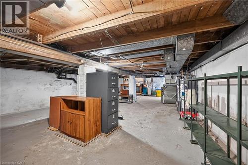 Unfinished basement with concrete flooring, exposed wood ceiling beams, painted cinder block walls, and visible ductwork - 155 Newlands Avenue, Hamilton, ON - Indoor Photo Showing Basement