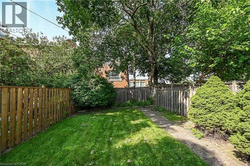 Generous outdoor space featuring a lush lawn, mature trees, well-maintained privacy fencing, and established shrubs - 155 Newlands Avenue, Hamilton, ON - Outdoor