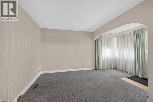 Room featuring light-toned striped wallpaper, gray carpeting, and white baseboards - 155 Newlands Avenue, Hamilton, ON - Indoor Photo Showing Other Room