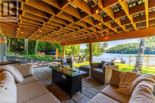 Lower waterproof patio area with fire table. - 1558 Fish Hatchery Road Unit# 10, Muskoka Lakes, ON - Outdoor With Deck Patio Veranda