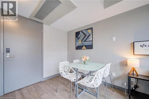 Interior space featuring wood-finish flooring, light gray walls, and a recessed ceiling vent - 321 Spruce Street Unit# 710, Waterloo, ON - Indoor Photo Showing Dining Room