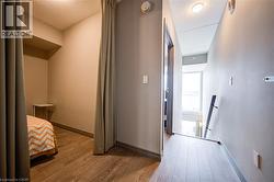 Hallway featuring wood-finish flooring, recessed lighting, and neutral wall tones - 