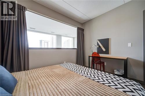 Room featuring a low wall partition with an upper horizontal window - 321 Spruce Street Unit# 710, Waterloo, ON - Indoor Photo Showing Bedroom
