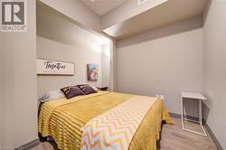 Recessed sleeping area with light neutral wall tones, wood-finish flooring, and a low profile baseboard trim - 