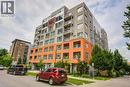 Modern multi-story building featuring a distinctive orange and gray facade - 321 Spruce Street Unit# 710, Waterloo, ON  - Outdoor With Facade 