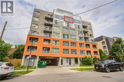 Modern multi-story building featuring a distinctive orange and gray facade - 321 Spruce Street Unit# 710, Waterloo, ON - Outdoor With Facade