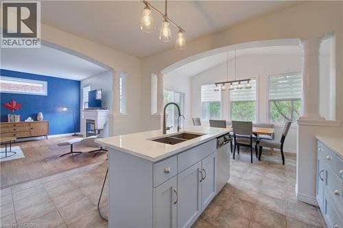Kitchen island with an undermount sink, quartz countertop, and light gray cabinetry - 729 Keats Way, Waterloo, ON - Indoor Photo Showing Kitchen With Double Sink