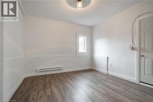 Room with wood-finish flooring, white walls, and a single window - 524 King Street E Unit# 3, Hamilton, ON - Indoor Photo Showing Other Room