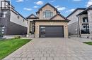 Contemporary two-story residence featuring a light brick facade and dark trim accents - 2195 Ironwood Road, London, ON  - Outdoor 