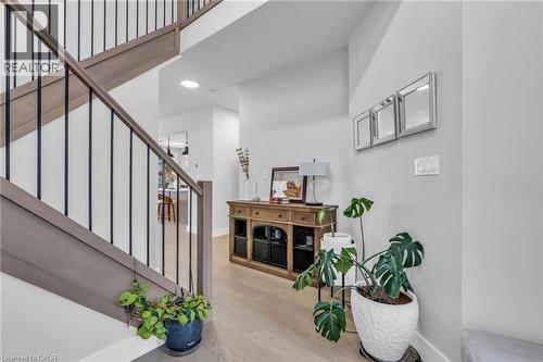 Staircase featuring wood-finish railings with black metal balusters - 2195 Ironwood Road, London, ON - Indoor Photo Showing Other Room