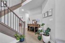 Staircase featuring wood-finish railings with black metal balusters - 