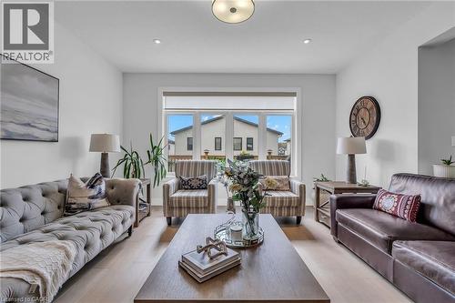 Spacious living area featuring light wood-finish flooring, a large window, recessed lighting, and a prominent ceiling fixture - 2195 Ironwood Road, London, ON - Indoor Photo Showing Living Room