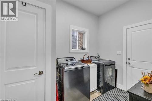 Dedicated laundry area with light gray walls, white trim, and a small window - 2195 Ironwood Road, London, ON - Indoor Photo Showing Laundry Room