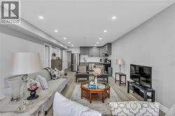 Open-concept living area featuring recessed lighting and light wood-finish flooring - 