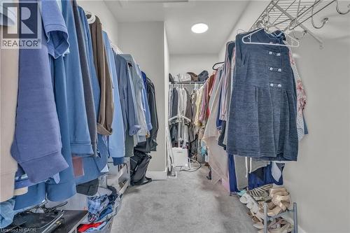 Walk-in closet with carpet flooring, recessed ceiling lighting, and multiple shelving and hanging storage systems - 2195 Ironwood Road, London, ON - Indoor With Storage