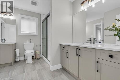 Contemporary bathroom featuring a double vanity with light gray cabinetry, white countertops, and chrome fixtures - 2195 Ironwood Road, London, ON - Indoor Photo Showing Bathroom