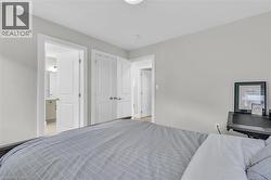 Bedroom featuring light neutral wall tones and white trim - 