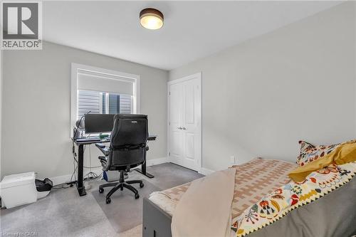 Neutral tone walls with white trim, gray carpeting, and a flush mount ceiling light - 2195 Ironwood Road, London, ON - Indoor