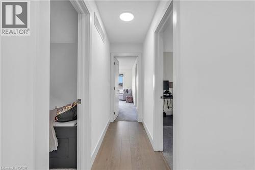 Modern hallway featuring wide-plank wood-finish flooring, white walls, and recessed lighting - 2195 Ironwood Road, London, ON - Indoor Photo Showing Other Room