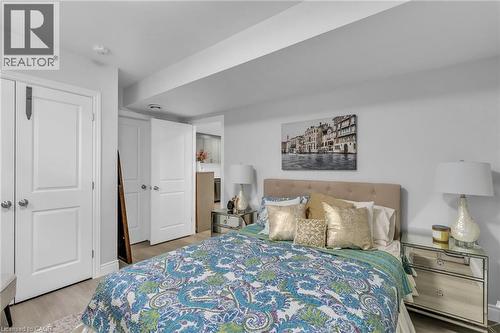 Light wood-finish flooring with white baseboards - 2195 Ironwood Road, London, ON - Indoor Photo Showing Bedroom