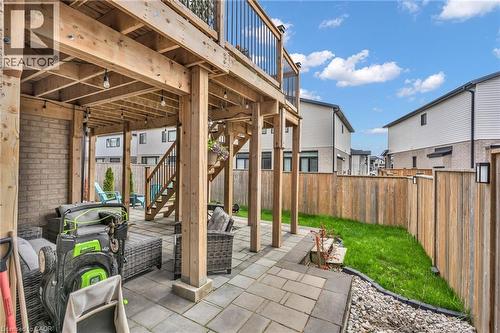 Private backyard featuring a paved patio area, wooden privacy fence, and a manicured lawn - 2195 Ironwood Road, London, ON - Outdoor With Deck Patio Veranda