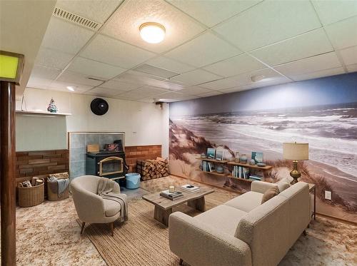Virtually staged Rec Room - 129 St Michael Road, Winnipeg, MB - Indoor With Fireplace