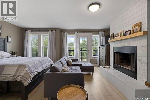 68 Deercrest Run, Lumsden Rm No. 189, SK - Indoor Photo Showing Bedroom With Fireplace
