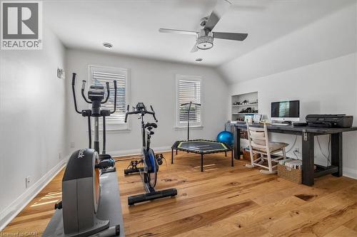 Bedroom room with vaulted ceilings, wood-finish flooring, recessed lighting, and built-in shelving - 573 Beach Boulevard, Hamilton, ON - Indoor Photo Showing Gym Room