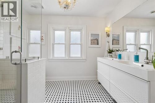 White bathroom featuring black and white hexagonal floor tiling - 573 Beach Boulevard, Hamilton, ON - Indoor Photo Showing Bathroom