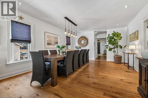 Open-concept dining area featuring wood-finish flooring, white shiplap ceiling, recessed lighting, and a linear pendant light fixture - 573 Beach Boulevard, Hamilton, ON - Indoor Photo Showing Dining Room