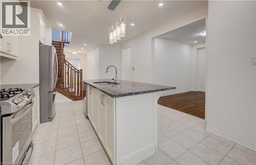 Kitchen island featuring a sink with a gooseneck faucet and a speckled countertop - 52 Pointer Street, Cambridge, ON - Indoor Photo Showing Kitchen With Upgraded Kitchen