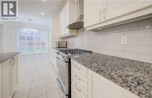 Kitchen featuring cream-colored cabinetry, granite countertops, and a subway tile backsplash - 52 Pointer Street, Cambridge, ON - Indoor Photo Showing Kitchen With Upgraded Kitchen